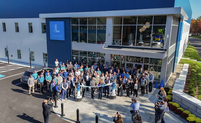 Locus Robotics team gathered outside the global headquarters for a ribbon-cutting celebration